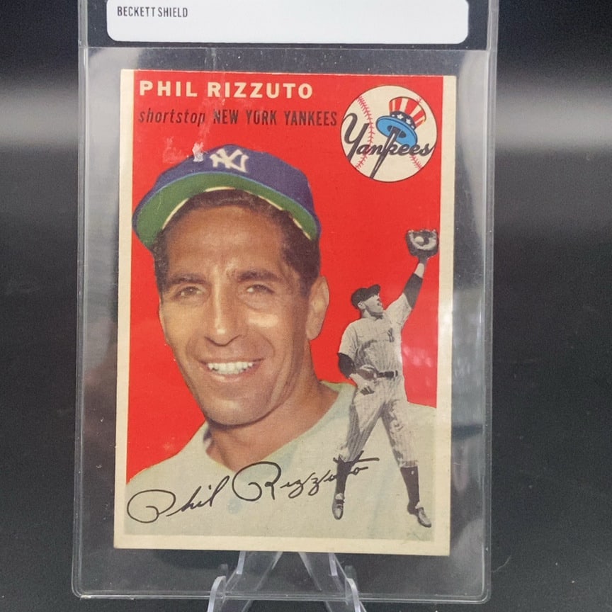 1954 Topps Phil Rizzuto #17 baseball card: This is a vintage trading card featuring Phil Rizzuto, the shortstop for the New York Yankees. The card displays a portrait of Rizzuto alongside a full-body action shot and his facsimile signature.