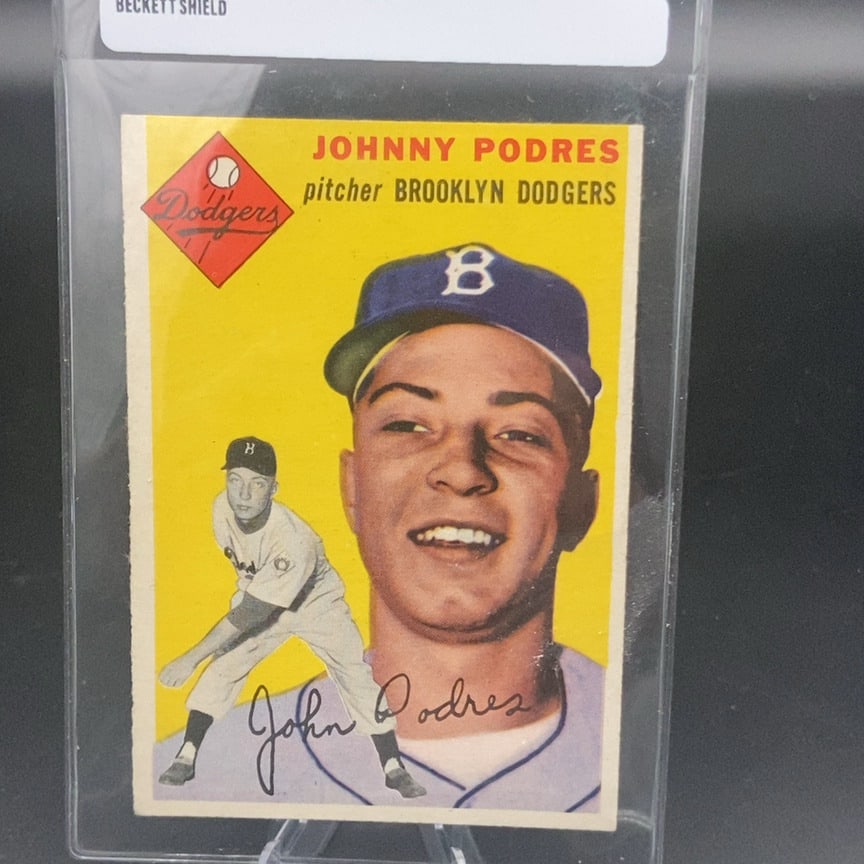 1954 Topps #166 Johnny Podres baseball card: This is a 1954 Topps baseball card featuring pitcher Johnny Podres of the Brooklyn Dodgers. The card features a distinct yellow background with both a headshot and a full-body action shot of the