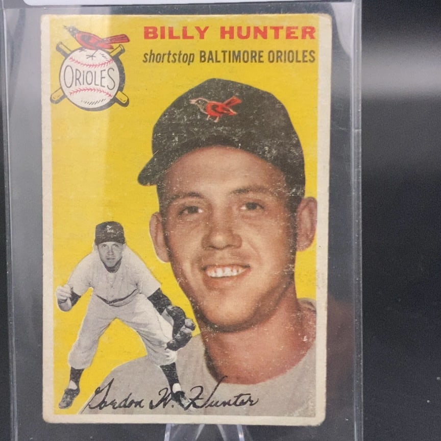 1954 Topps Billy Hunter Baltimore Orioles Baseball Card: This is a vintage 1954 Topps baseball card featuring Billy Hunter of the Baltimore Orioles. The front of the card displays a portrait and a full-body action shot of the player, along with his printed