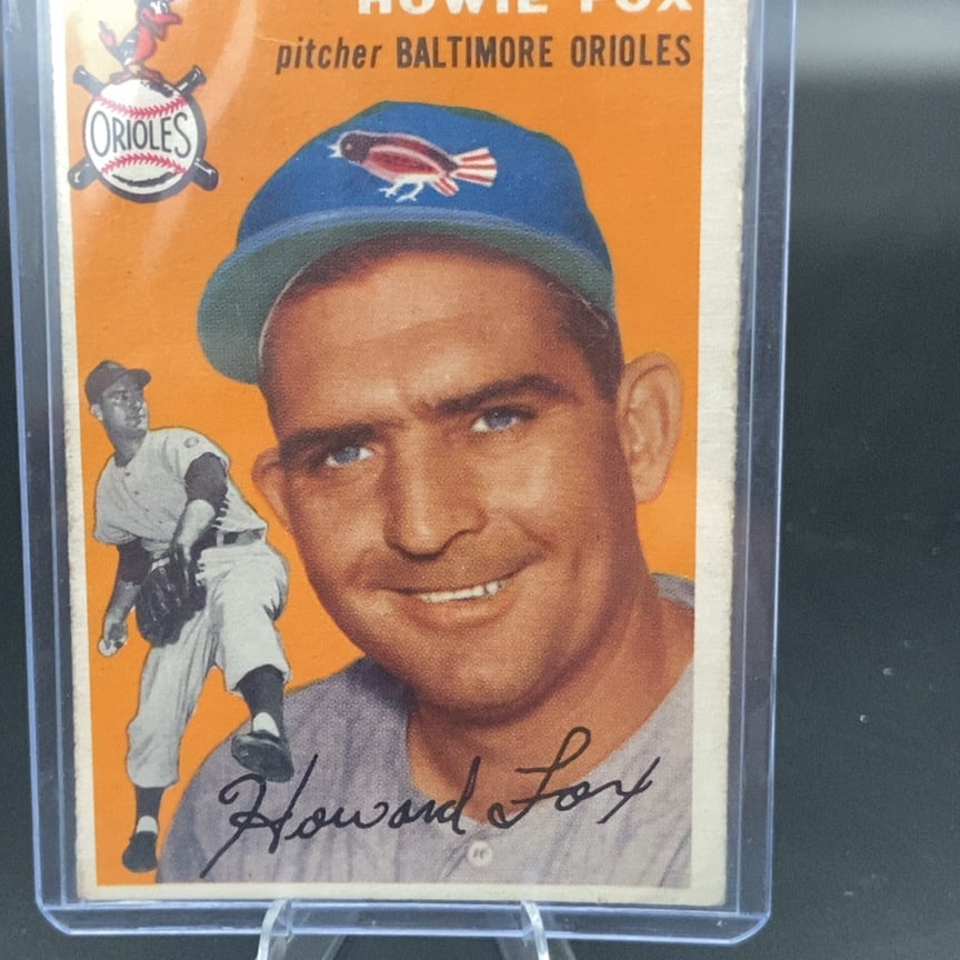 1954 Topps Howie Fox Baseball Card: This is a 1954 Topps baseball card featuring Baltimore Orioles pitcher Howie Fox. The card displays a portrait of the player alongside a smaller action image and the team logo.
