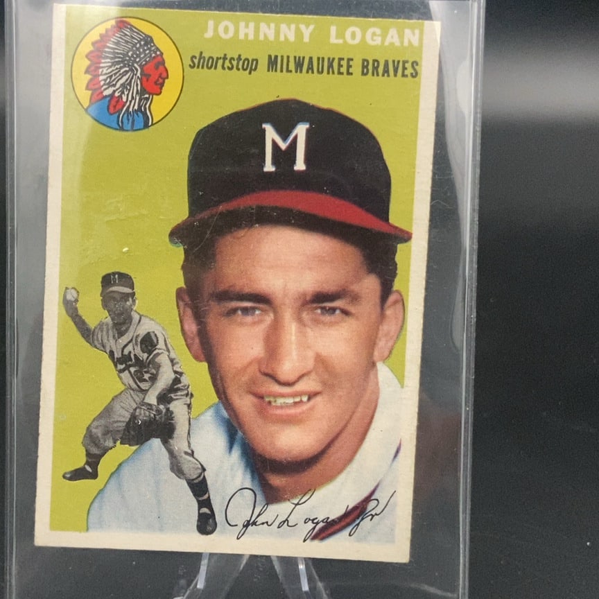 1954 Topps Johnny Logan Milwaukee Braves Baseball Card: This is a 1954 Topps baseball card featuring Johnny Logan of the Milwaukee Braves. The card features a portrait of the shortstop and a small action figure in the lower left corner, along with the