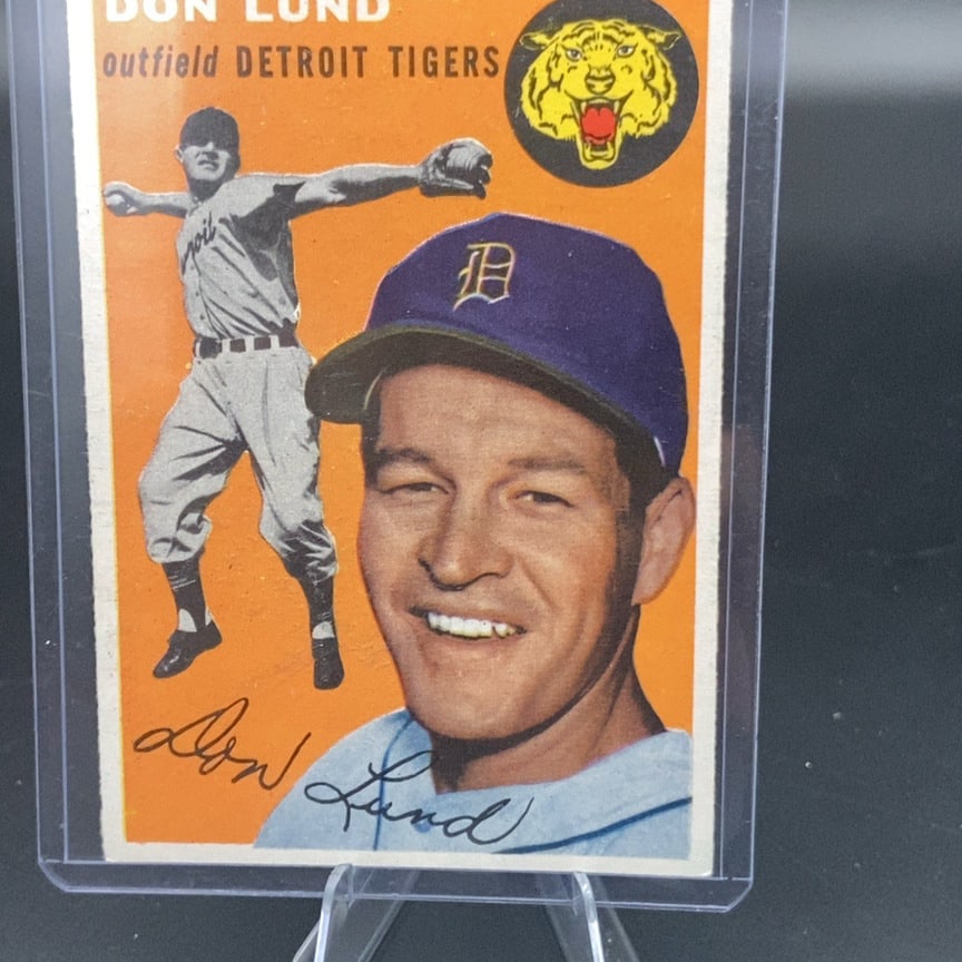 1954 Topps Don Lund Detroit Tigers Baseball Card: This is a 1954 Topps baseball card featuring outfielder Don Lund of the Detroit Tigers. The card displays a vibrant orange background with a tiger logo and a facsimile autograph of the player. It is