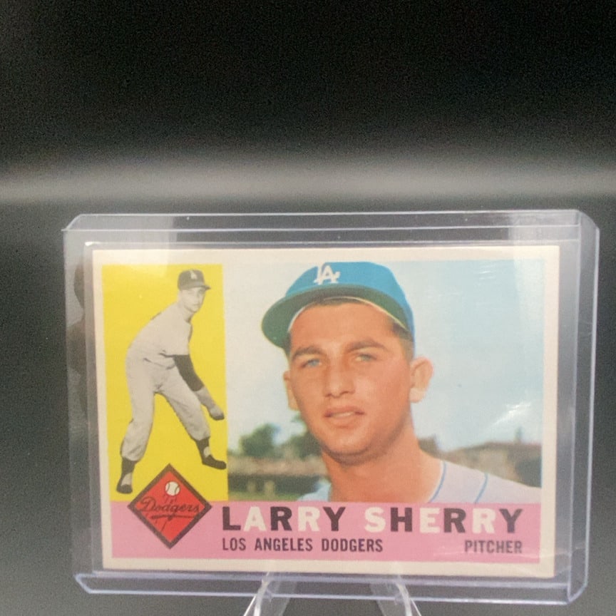 1960 Topps Baseball Card #105 Larry Sherry: This is a 1960 Topps trading card featuring Larry Sherry, a pitcher for the Los Angeles Dodgers. The card includes both a close-up portrait and a full-body action shot of the player.