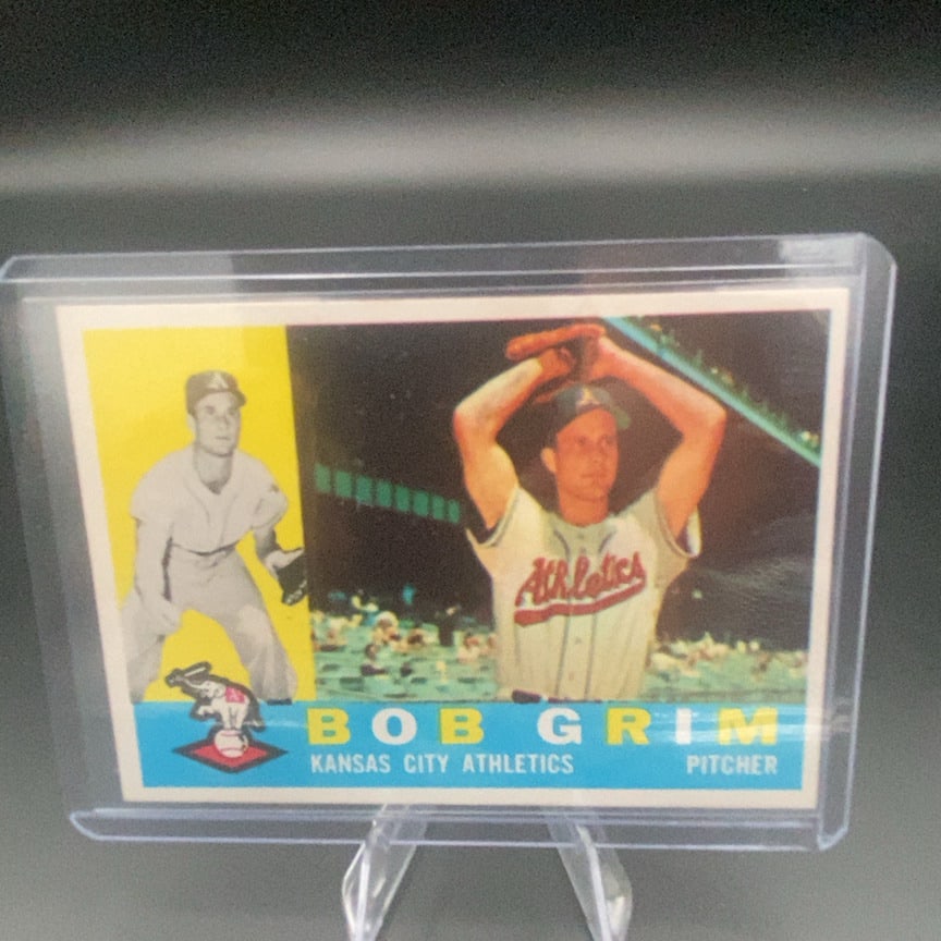 1960 Topps Bob Grim #78 baseball trading card: This is a 1960 Topps trading card featuring Bob Grim, a pitcher for the Kansas City Athletics. The card features a classic dual-image design and the iconic Athletics elephant logo.