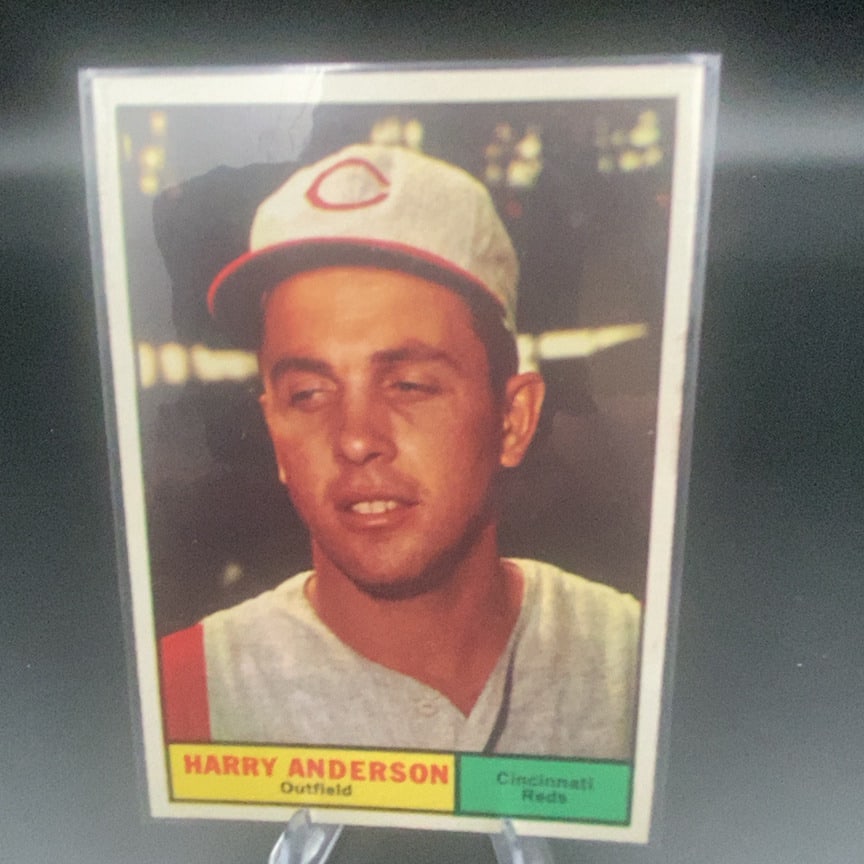 1961 Topps #76 Harry Anderson baseball trading card: This is a 1961 Topps baseball card featuring Harry Anderson of the Cincinnati Reds. The card shows a close-up portrait of the outfielder in his Reds uniform.