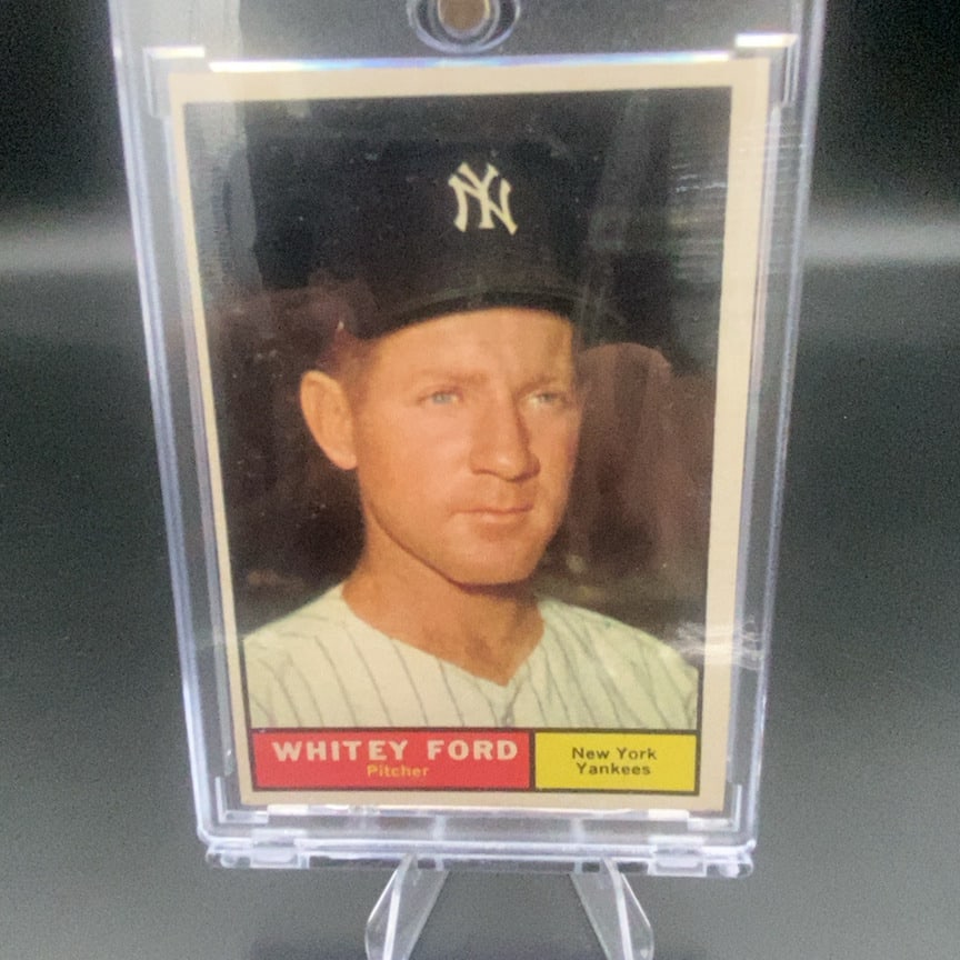 1961 Topps Whitey Ford #160 baseball card: This is a vintage trading card featuring Whitey Ford, the pitcher for the New York Yankees. The card displays a headshot of the player with his name and team information clearly marked in a colorful