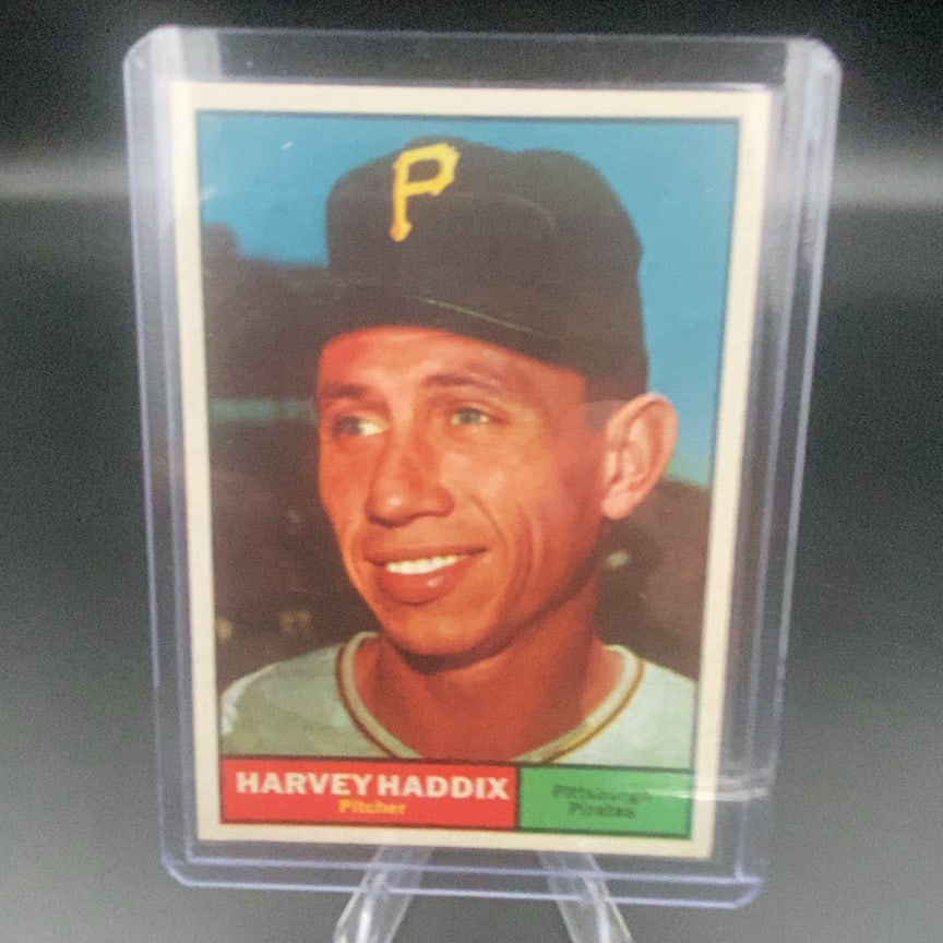 1961 Topps #100 Harvey Haddix baseball card: This is a vintage baseball trading card featuring pitcher Harvey Haddix of the Pittsburgh Pirates. The card shows a close-up portrait of the player wearing his Pirates cap. It is preserved in a