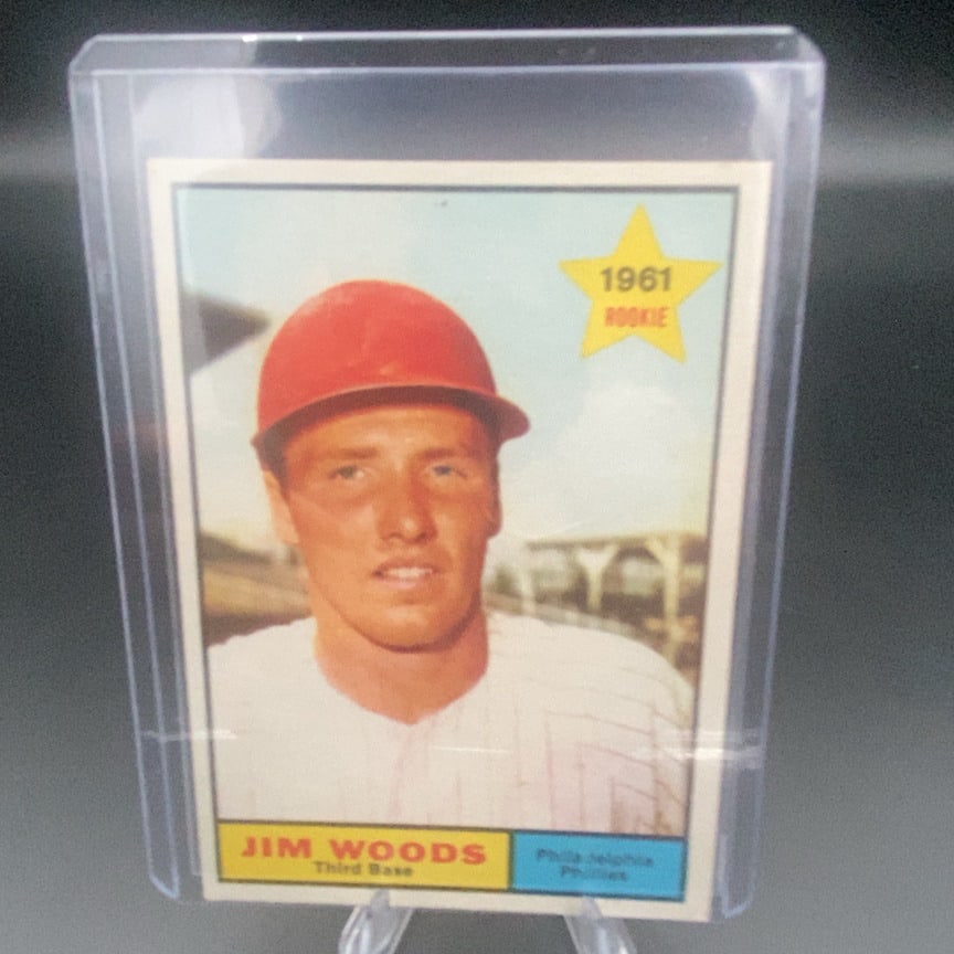 1961 Topps Baseball #59 Jim Woods rookie card: This is a 1961 Topps baseball card featuring Jim Woods, who plays third base for the Philadelphia Phillies. The card highlights him as a 1961 Rookie with a distinct star graphic.