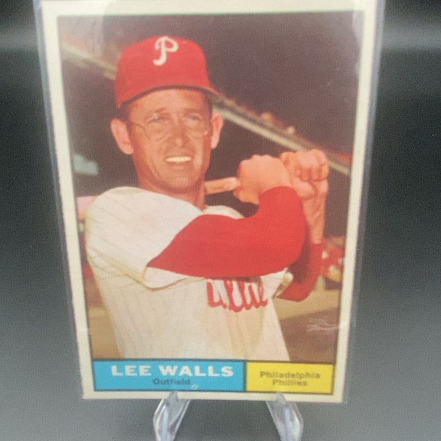 1961 Topps #78 Lee Walls baseball card: This is a vintage baseball card featuring Lee Walls of the Philadelphia Phillies. He is depicted in a batting stance wearing the team's cap and uniform.