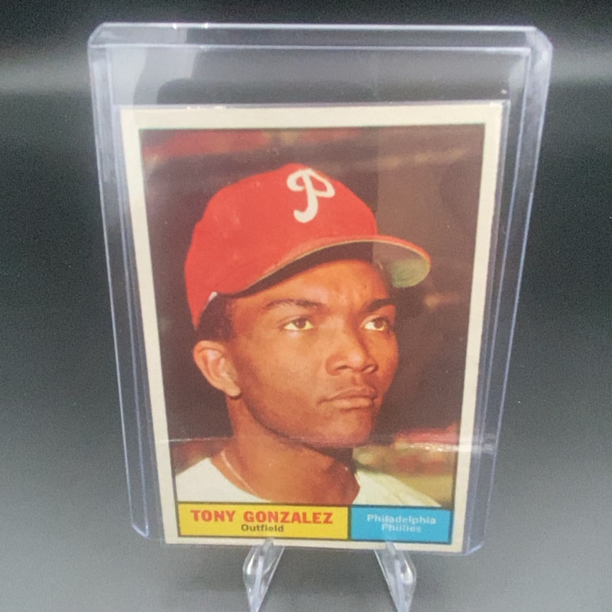 1961 Topps baseball card (#93) of outfielder Tony Gonzalez: This is a 1961 Topps baseball card featuring Tony Gonzalez of the Philadelphia Phillies. It is an outfield position card encased in a protective plastic holder.