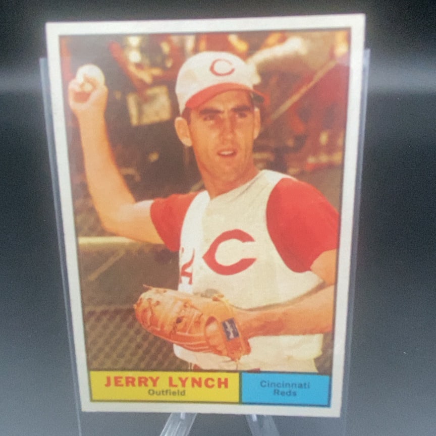 1961 Topps Jerry Lynch baseball card (#97): This is a vintage baseball card featuring Jerry Lynch of the Cincinnati Reds. The card shows Lynch in his team uniform holding a baseball and wearing a mitt.