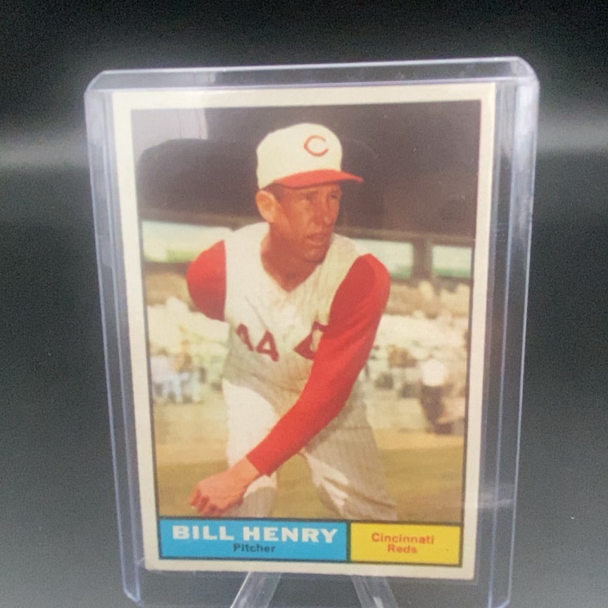 1961 Topps #66 Bill Henry Cincinnati Reds baseball card: This is a 1961 Topps baseball card featuring Bill Henry of the Cincinnati Reds. The card is preserved in a rigid plastic toploader case. It showcases a vintage color portrait of the pitcher.