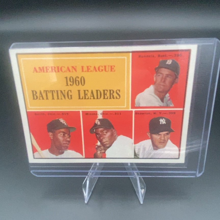 1961 Topps American League 1960 Batting Leaders #42 baseball trading card: This is a 1961 Topps trading card highlighting American League batting leaders. It features portraits of players Runnels, Smith, Minoso, and Skowron.