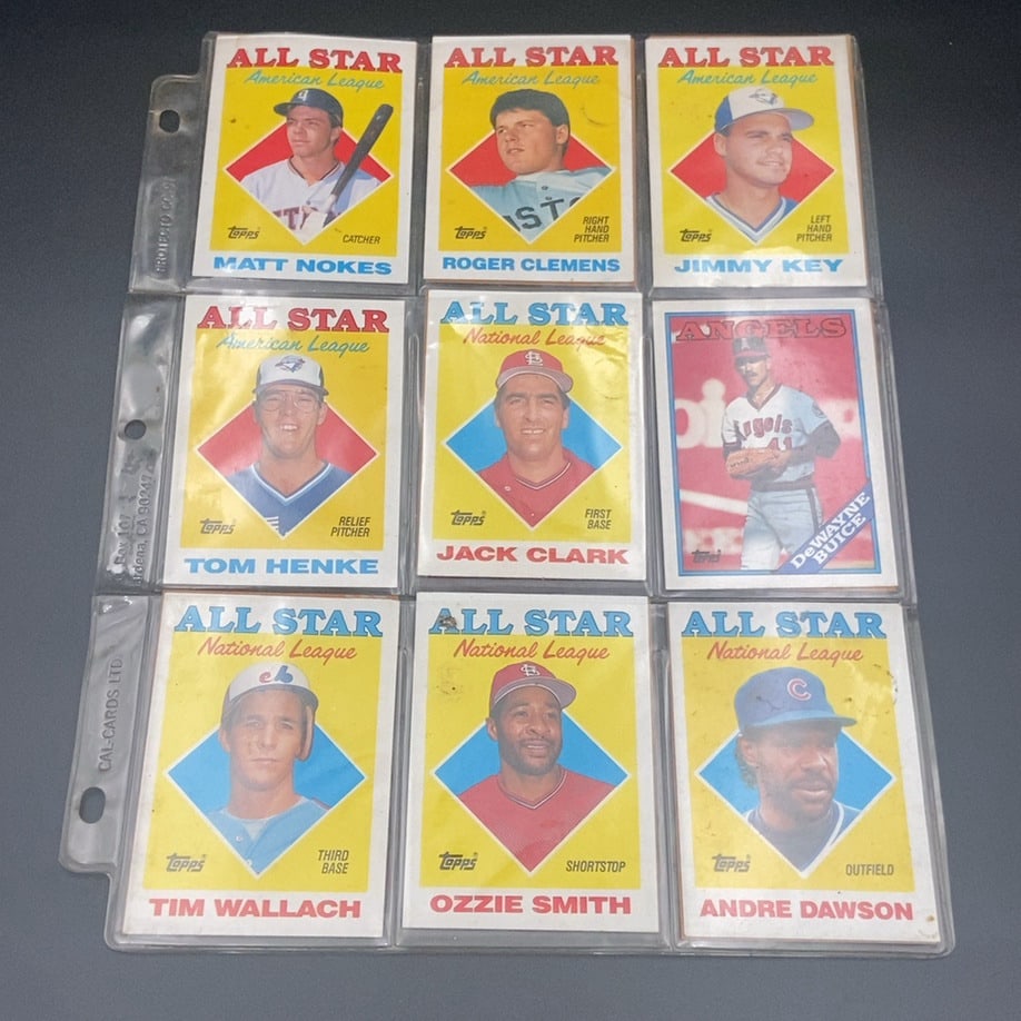 1988 Topps All-Star Trading Card Collection: This is a collection of nine 1988 Topps baseball cards featuring various All-Star players, including Ozzie Smith, Andre Dawson, Roger Clemens, and Matt Nokes. The cards are arranged in a protective