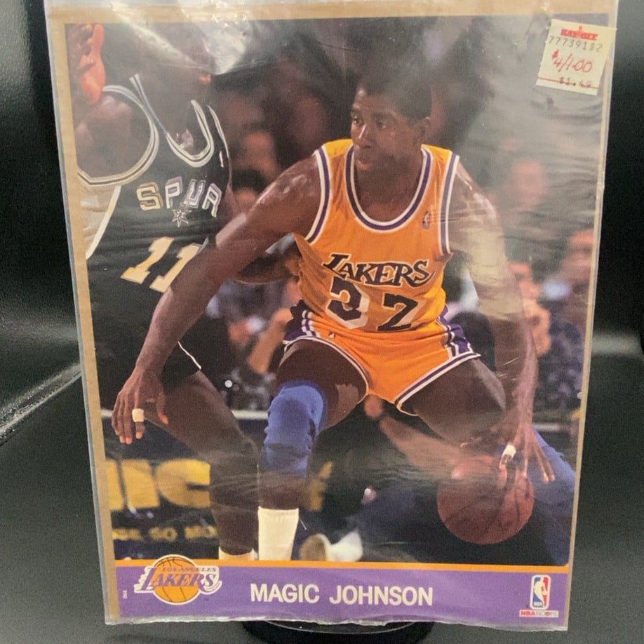 1990–1991 NBA Hoops action photo of Hall of Fame point guard Magic Johnson: This is a 1990 NBA Hoops basketball trading card featuring Los Angeles Lakers legend Magic Johnson in action. The card remains inside its original protective plastic sleeve, which includes a vintage