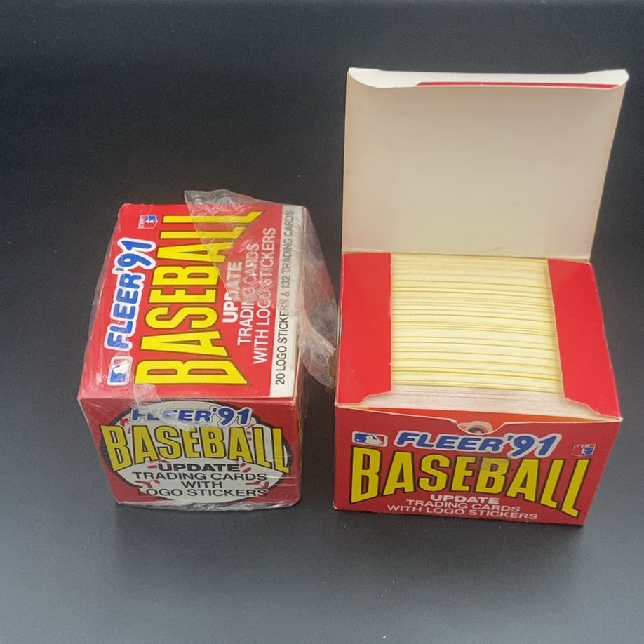 1991 Fleer Baseball Update Set: This is a 1991 Fleer Baseball Update set including trading cards and logo stickers. The item is displayed as both a wrapped box and an opened box, clearly showing the 1991 Fleer branding and the