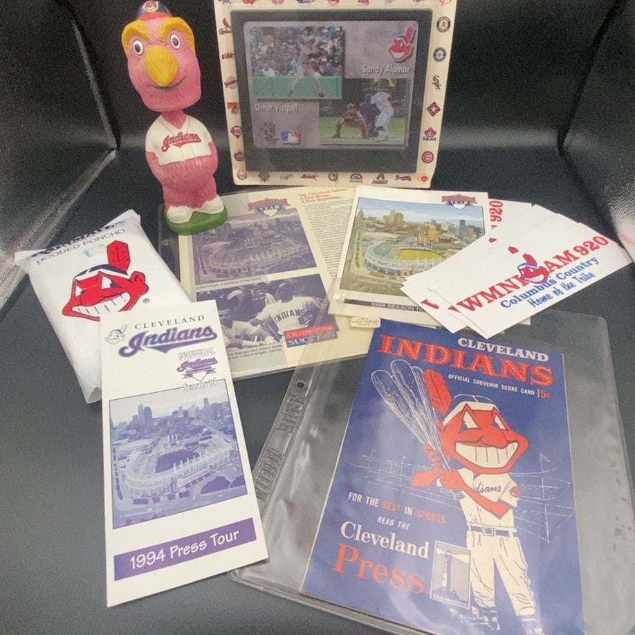 Cleveland Indians 1994 Memorabilia Lot: A collection of 1994 Cleveland Indians baseball memorabilia including a bobblehead, a scorecard, press tour materials, and promotional items. This set celebrates the team's move to a new stadium and