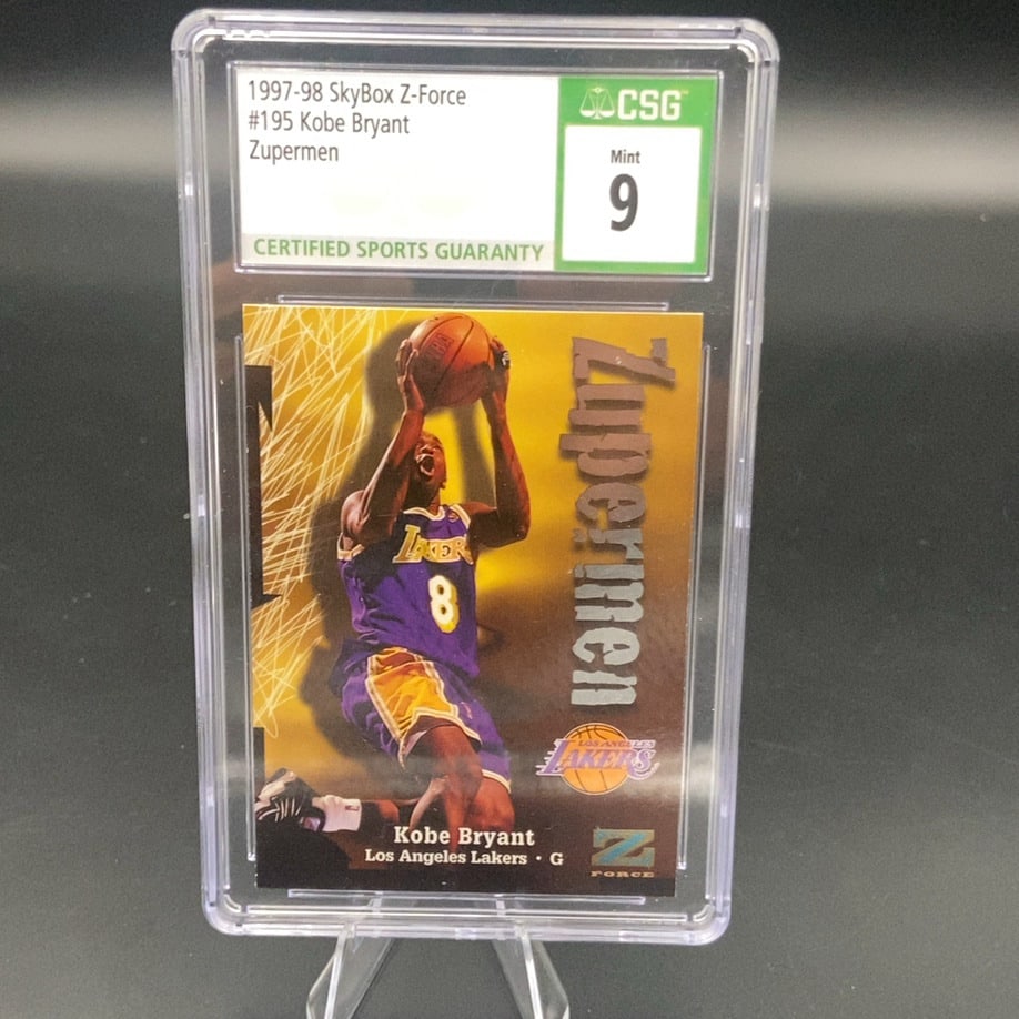 1997-98 SkyBox Z-Force Kobe Bryant Zupermen CSG 9: This is a 1997-98 SkyBox Z-Force Zupermen basketball card featuring Kobe Bryant of the Los Angeles Lakers. The card is professionally graded by CSG with a Mint 9 rating. It is a highly sought-after