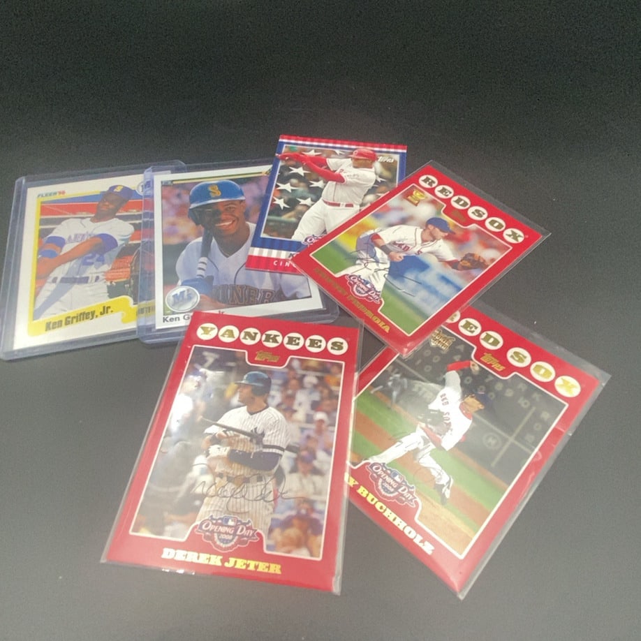 2008 Topps Opening Day Baseball Cards Lot: This lot features several baseball trading cards from the 2008 Topps Opening Day series. Notable players included are Derek Jeter, Dustin Pedroia, and Clay Buchholz. The cards are encased in protectiv