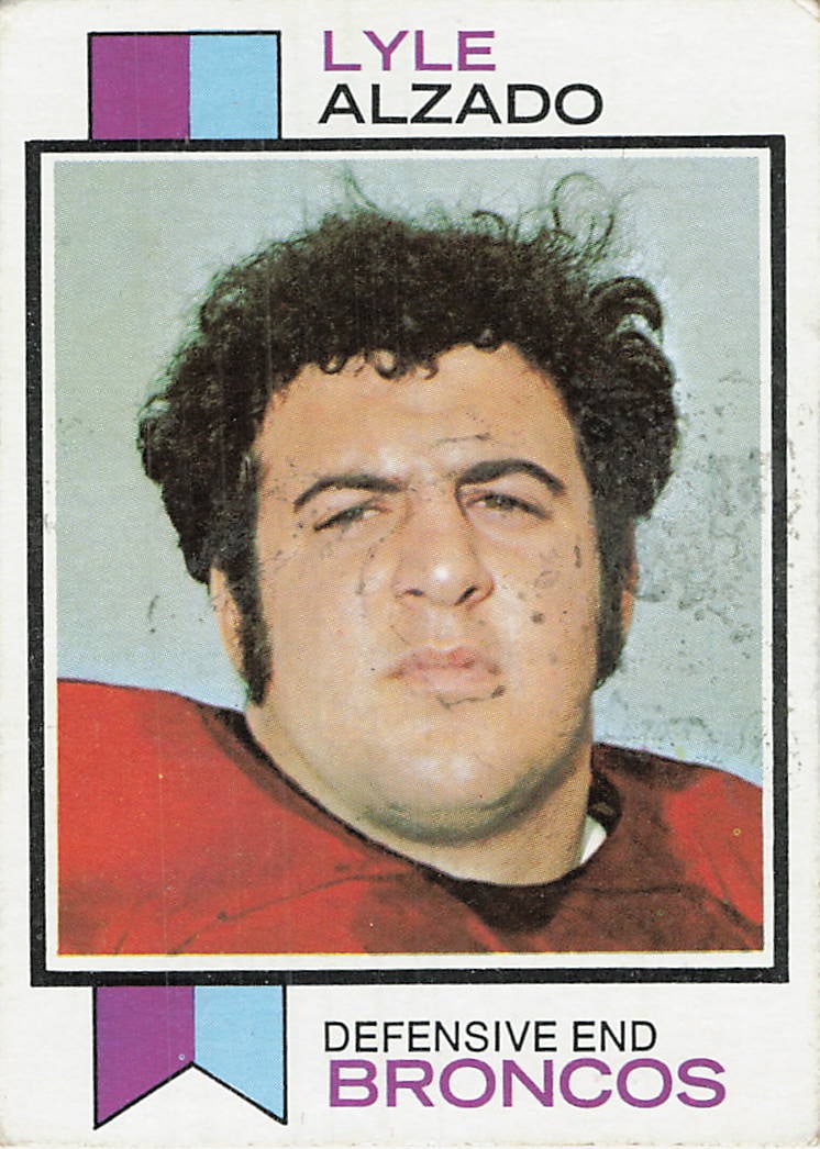 1973 Topps Lyle Alzado #312 football trading card: 1973 Topps Football Lyle Alzado #312 is a base trading card featuring Lyle Alzado during his tenure with the Denver Broncos. An early-career Broncos issue from Topps, this vintage release is known for