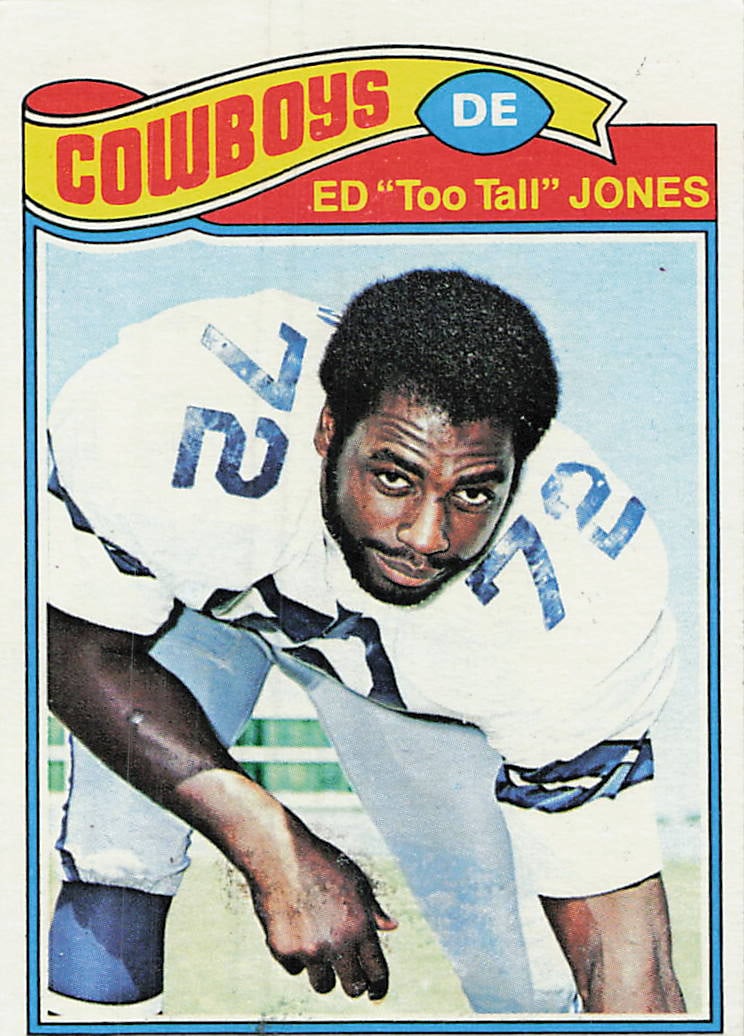 1977 Topps Ed "Too Tall" Jones #314 football trading card: 1977 Topps Football Ed "Too Tall" Jones #314 is a base trading card featuring Ed "Too Tall" Jones during his tenure with the Dallas Cowboys. This regular-issue 1977 Topps football card comes from the