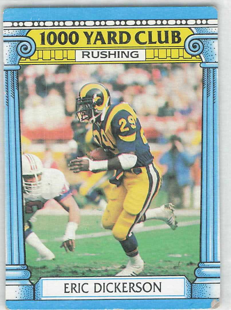 1987 Topps 1000 Yard Club #1 Eric Dickerson Los Angeles Rams football trading card: 1987 Topps 1000 Yard Club Eric Dickerson #1 is a base trading card featuring Eric Dickerson during his tenure with the Los Angeles Rams. This Topps subset highlights leading NFL rushers, with