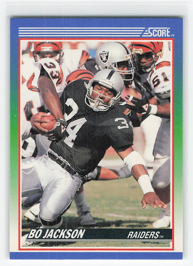 1990 Score Bo Jackson #10 football trading card: This is a 1990 Score football card featuring Bo Jackson, the standout running back for the Los Angeles Raiders. The card features Jackson in his Raiders uniform with the classic 1990 Score design, mak