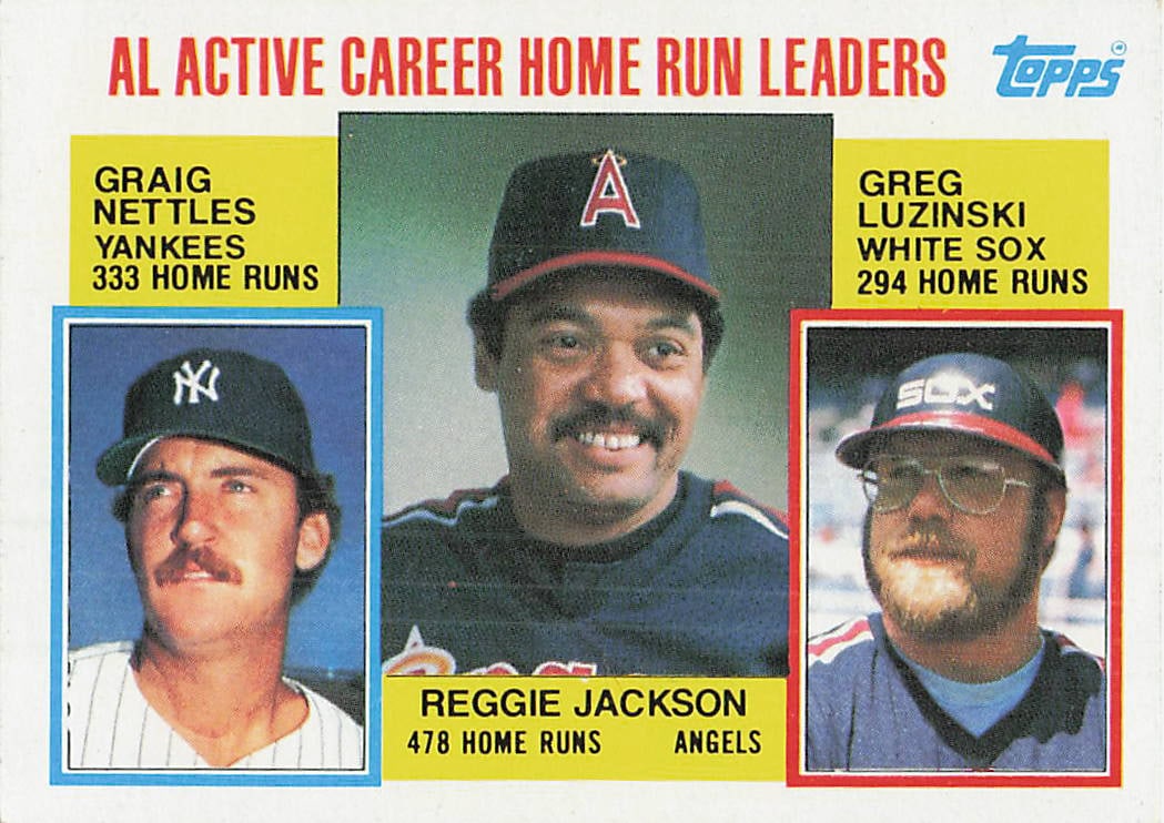 1984 Topps #712 AL Active Career Home Run Leaders baseball card: This is a 1984 Topps baseball card featuring the American League Active Career Home Run Leaders: Reggie Jackson, Graig Nettles, and Greg Luzinski. The card highlights these accomplished power hitters