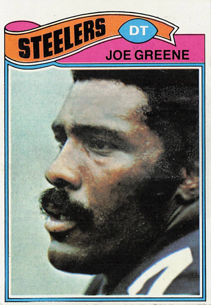 1977 Topps Joe Greene #405 football trading card: This is a 1977 Topps football trading card featuring Hall of Fame defensive tackle Joe Greene of the Pittsburgh Steelers. The card highlights Greene, a key member of the Steelers' legendary defense,
