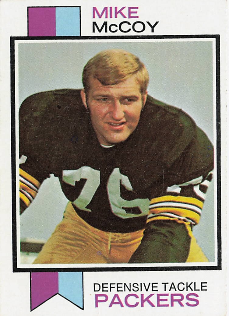 1973 Topps Mike McCoy football trading card (Number 296): This is a 1973 Topps football trading card featuring Mike McCoy of the Green Bay Packers. The card highlights McCoy during his NFL career and features the classic 1973 Topps design from the 1970s