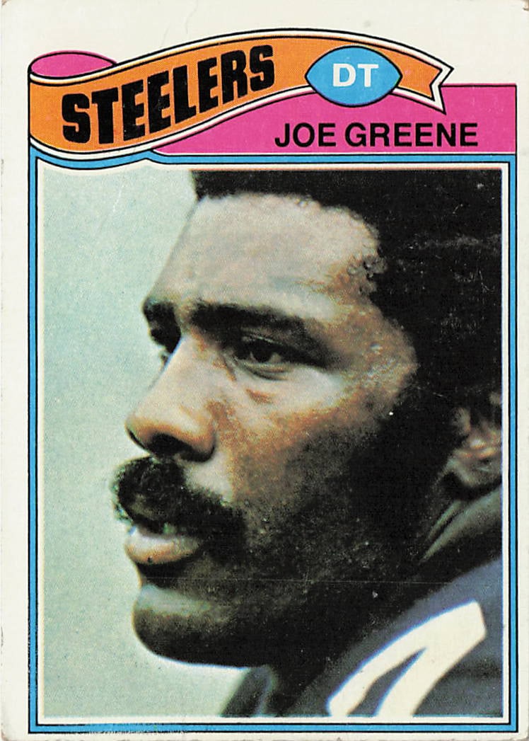1977 Topps Joe Greene Football Card #405: This is a 1977 Topps football trading card featuring Hall of Fame defensive tackle Joe Greene of the Pittsburgh Steelers. The card highlights Greene, a key member of the Steelers' legendary defense,