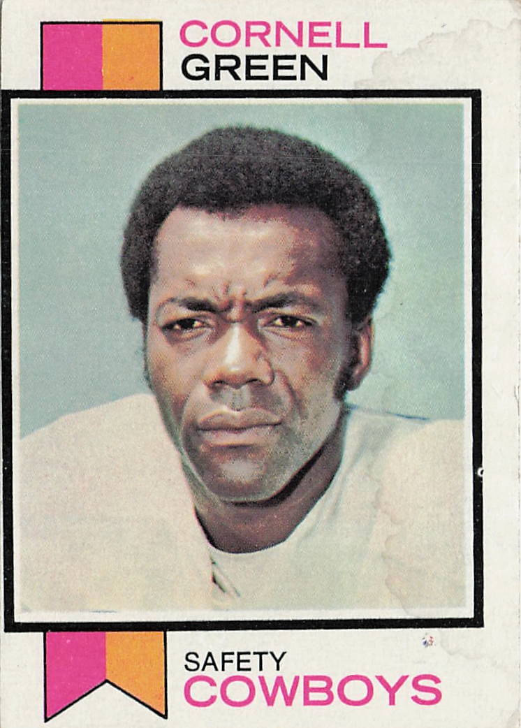 1973 Topps Cornell Green #344 football trading card: This is a 1973 Topps football trading card featuring Cornell Green of the Dallas Cowboys. The card highlights the standout safety during his successful NFL career and features the classic 1973 Topps d