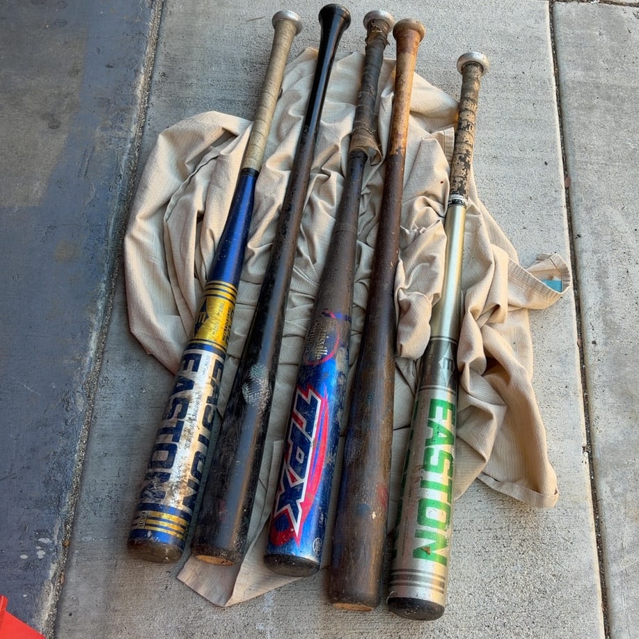 Lot of 5 Assorted Vintage Baseball Bats: This is a collection of five vintage baseball bats, including brands like Easton and Louisville Slugger TPX. The lot features a mix of aluminum and wooden bats in various stages of wear and use.