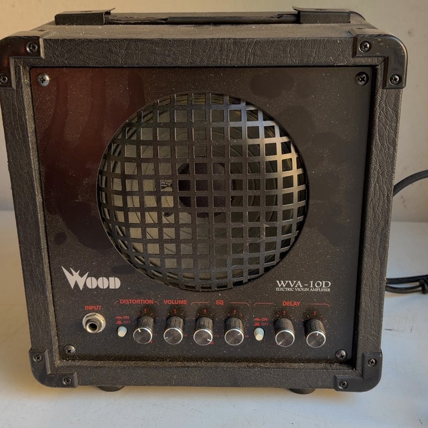 WOOD WVA-10D Electric Violin Amplifier: This is a WOOD WVA-10D electric violin amplifier designed to amplify the sound of electric violins and other compatible instruments. Its compact design makes it suitable for practice, performances,