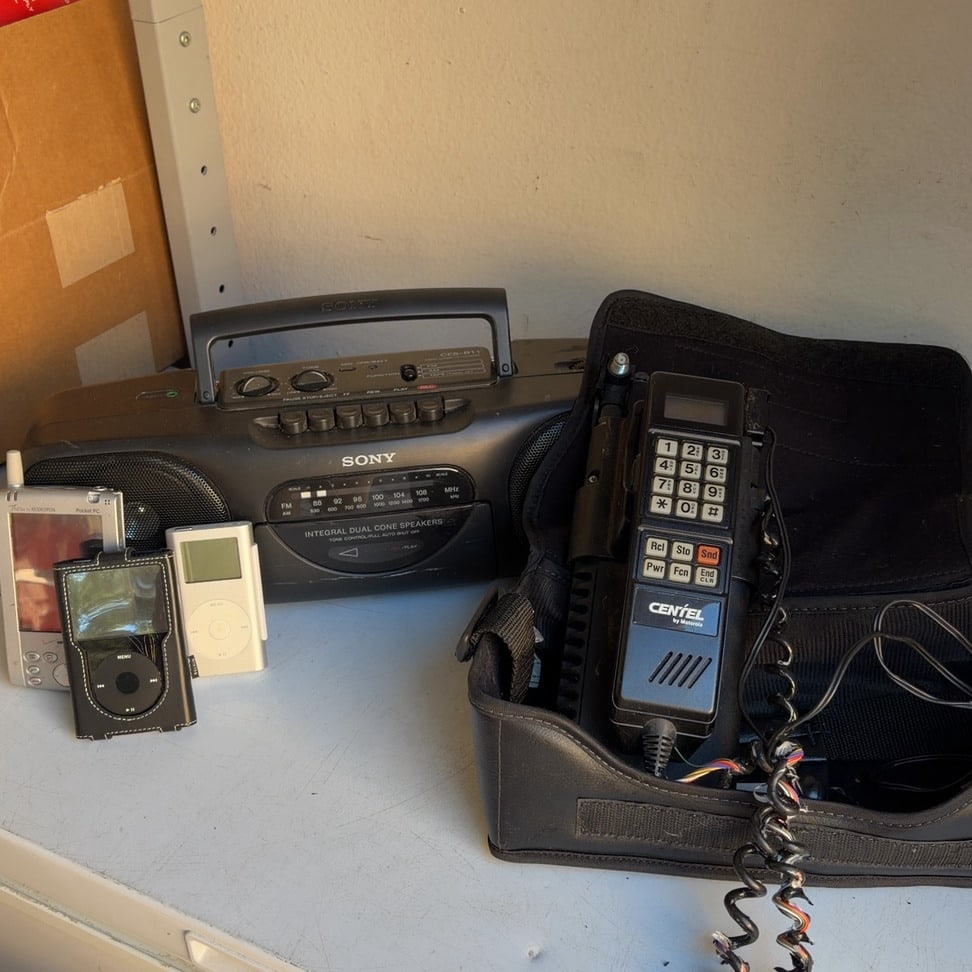 Sony Portable Boombox, Motorola Centel Cellular Phone & Assorted Electronics: This lot features a Sony portable boombox, Motorola Centel cellular phone, and assorted electronic equipment. The collection offers a variety of vintage and retro electronics, representing different