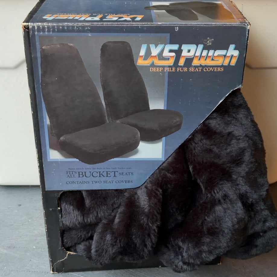 LXS Plush Deep Pile Fur Seat Covers: This is a vintage packaging box for LXS Plush deep pile fur seat covers. The set includes two seat covers designed to fit all bucket seats, featuring high or low back compatibility. The product is