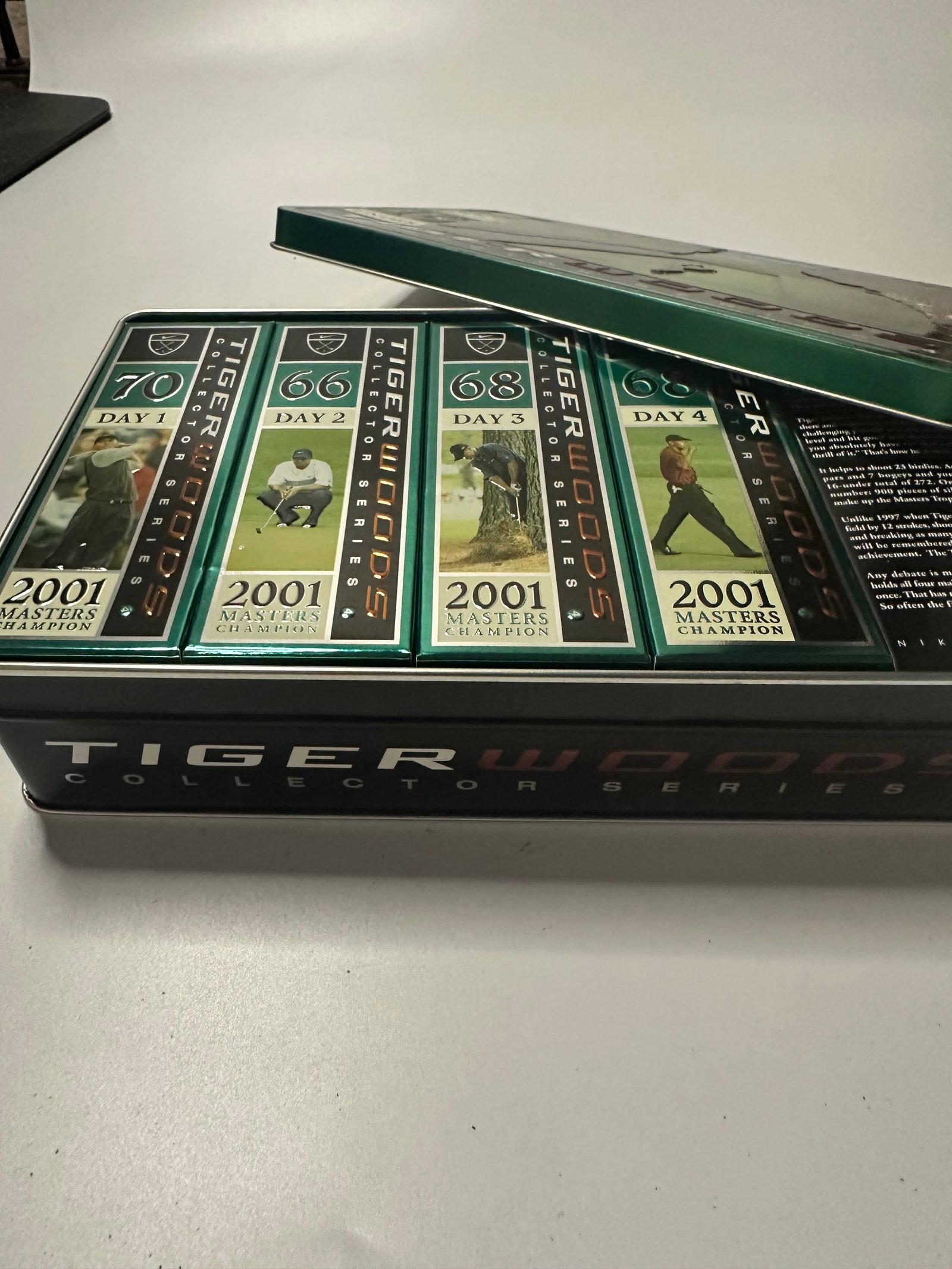 2001 Tiger Woods Collector Series Tin Set: This is a collectible tin set featuring Tiger Woods and his 2001 Masters Championship performance. The set includes individual card packs detailing his play across four days of the tournament.