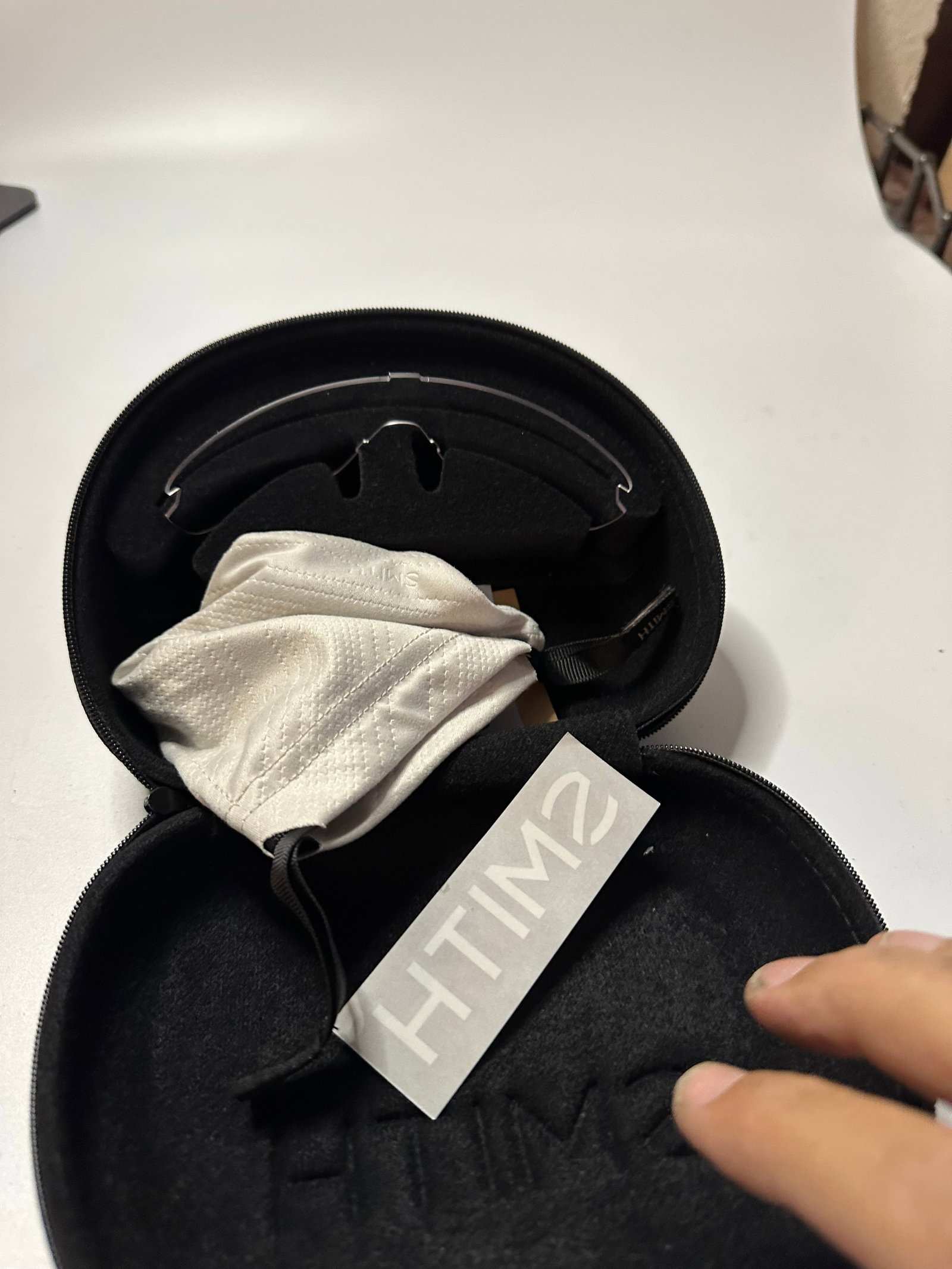 Smith Optics Protective Case: This is a black protective carrying case branded by Smith. It includes an interior storage compartment with a branded protective cloth pouch.