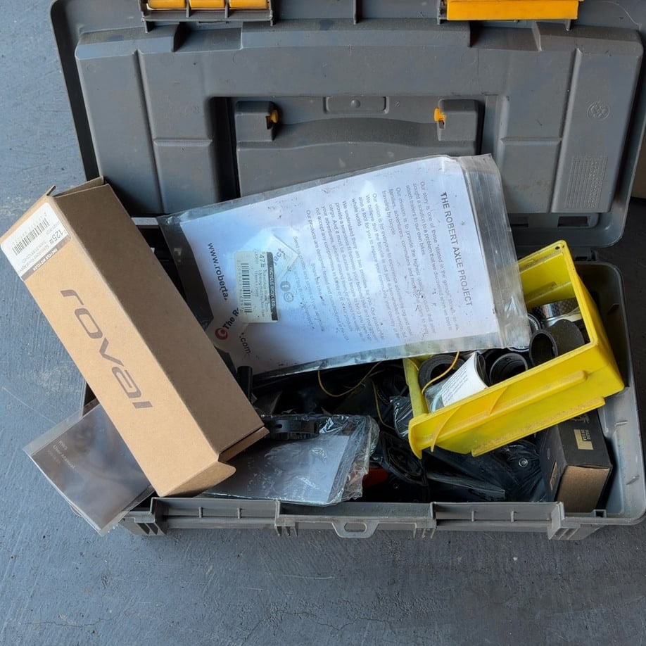 Robert Axle Project and Roval Bicycle Accessories: This lot features a collection of bicycle components and accessories contained within a storage case. Included are products from The Robert Axle Project and a Roval bicycle component box. Various