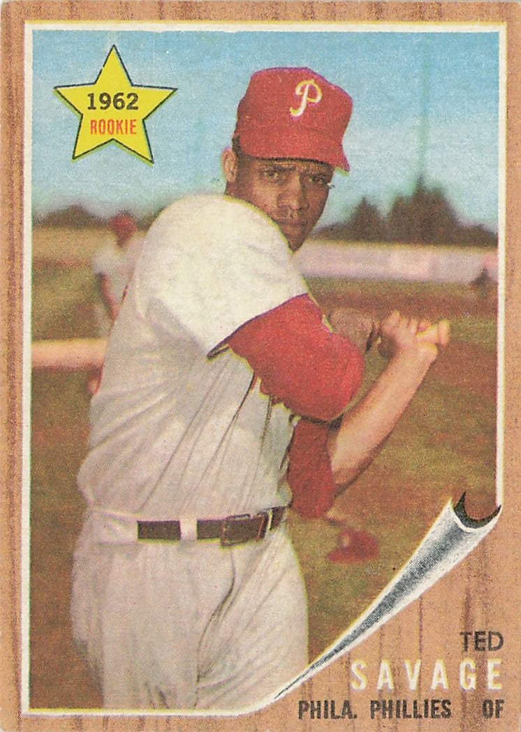 1962 Topps Ted Savage #104 baseball card: This vintage card marks the official rookie card designation for outfielder Ted Savage during his debut campaign with the Philadelphia Phillies. Part of the highly recognizable 1962 Topps set, the des