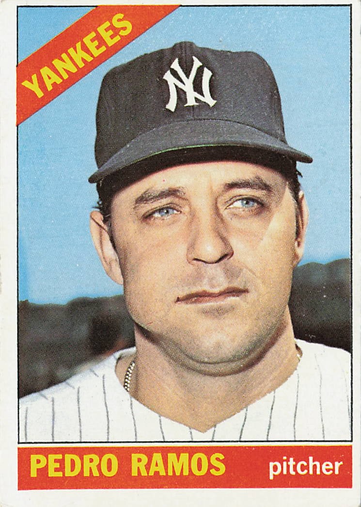 1966 Topps Pedro Ramos #439 baseball card: This vintage card features veteran right-handed pitcher Pedro Ramos in his iconic pinstripe New York Yankees uniform. True to the format of the 1966 Topps Base Set, it sports a vibrant orange color