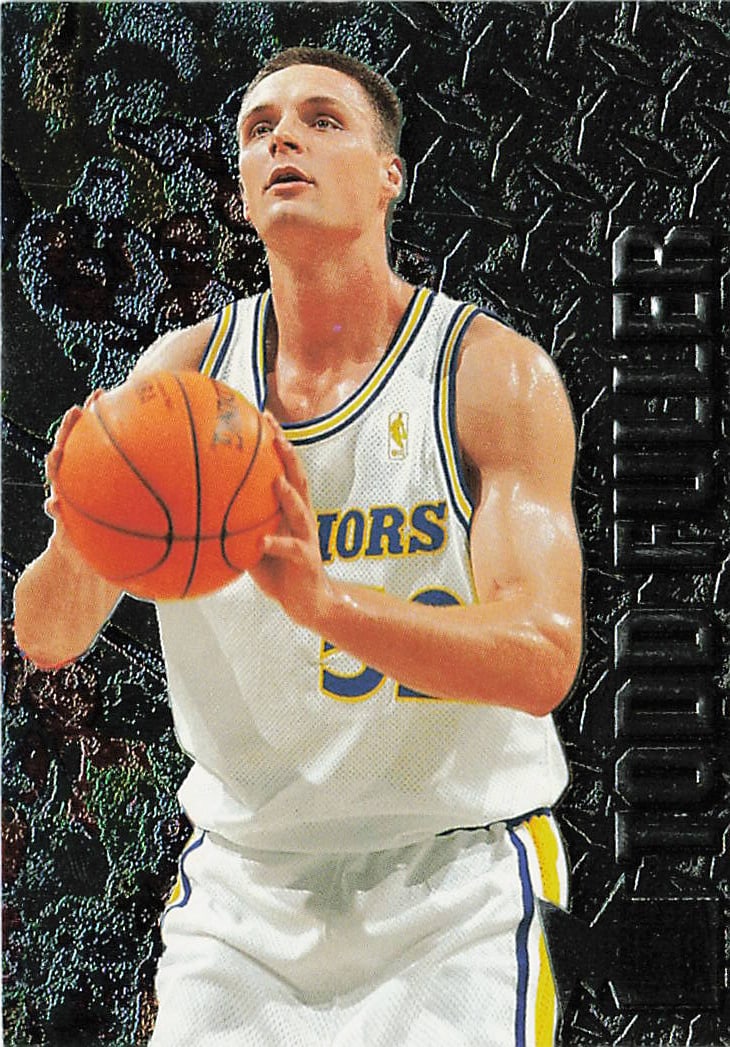 1996-97 Fleer Metal Todd Fuller #124 basketball trading car: This card comes from the highly popular, retro-styled 1996-97 Fleer Metal set. It captures rookie big man Todd Fuller tracking a shot or rebound while wearing the classic Golden State Warriors white