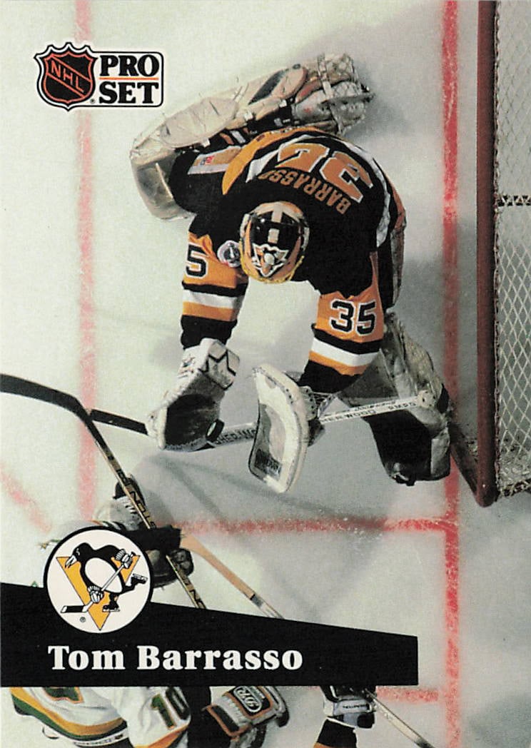 1991-92 Pro Set Tom Barrasso #517 trading card: The 1991-92 Pro Set Tom Barrasso #517 trading card features a borderless design framing a striking overhead action photograph of the Pittsburgh Penguins goaltender sprawled across the ice to make a