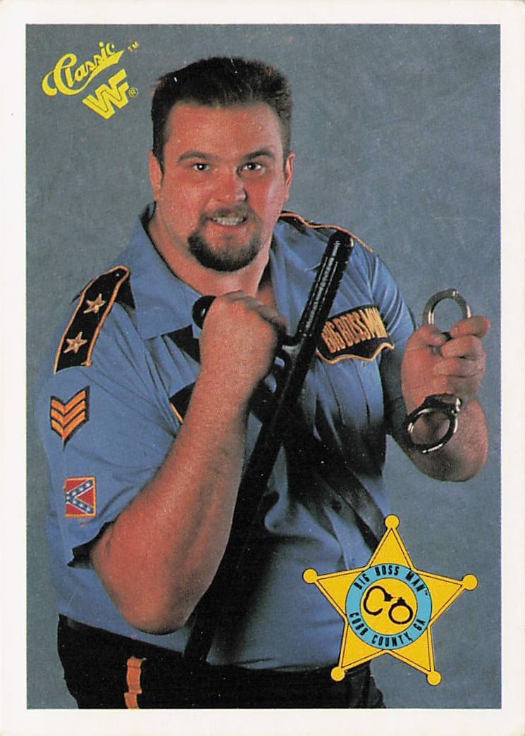 1990 Classic WWF Big Boss Man #4 trading card: The 1990 Classic WWF Big Boss Man #4 trading card features a blue, crumpled-texture border framing a portrait studio photograph of the iconic wrestler posing in his law enforcement guard uniform