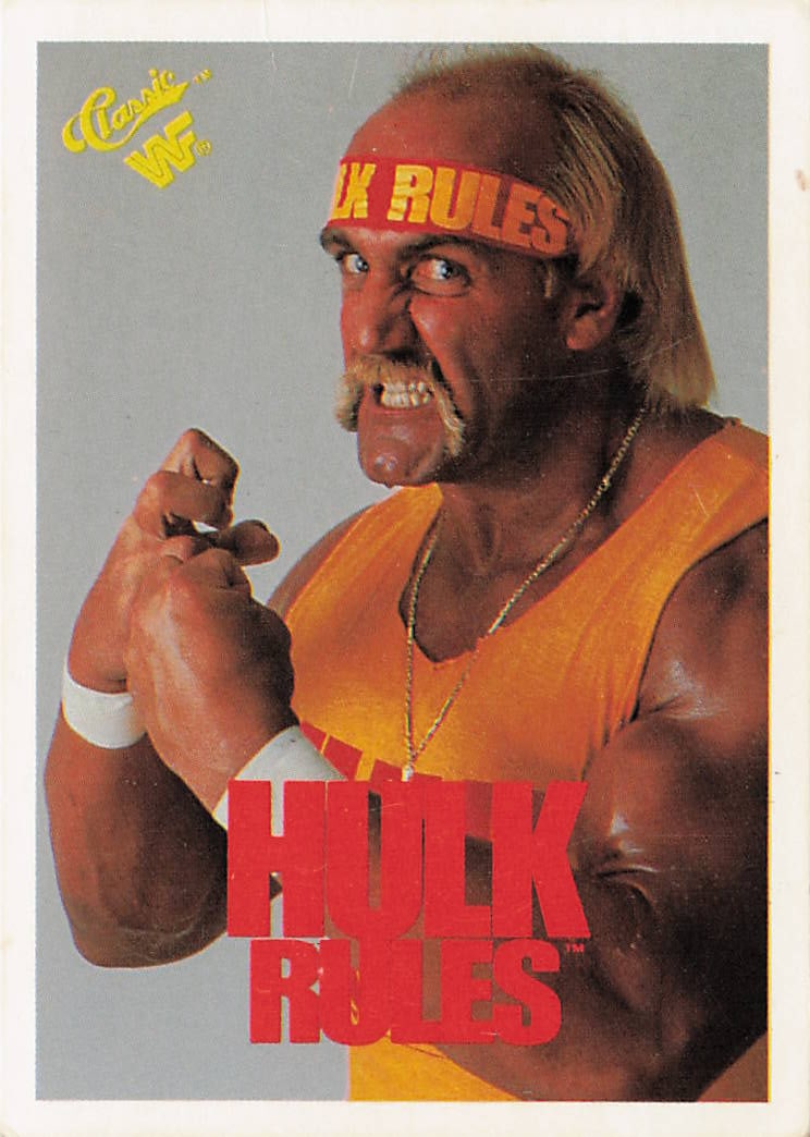 1990 Classic WWF Hulk Hogan "Hulk Rules" #1 trading card: The 1990 Classic WWF Hulk Hogan "Hulk Rules" #1 trading card features a thin white outer border framing an iconic promotional close-up photograph of the WWE Hall of Famer Hulk Hogan clenching his