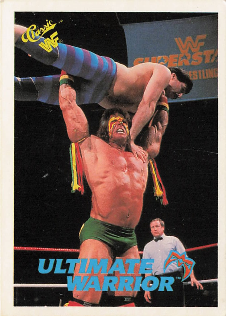 1990 Classic WWF Ultimate Warrior #45 trading card: The 1990 Classic WWF Ultimate Warrior #45 trading card features a thin white outer border framing a powerful in-ring action photograph of the WWE Hall of Famer The Ultimate Warrior hoisting an