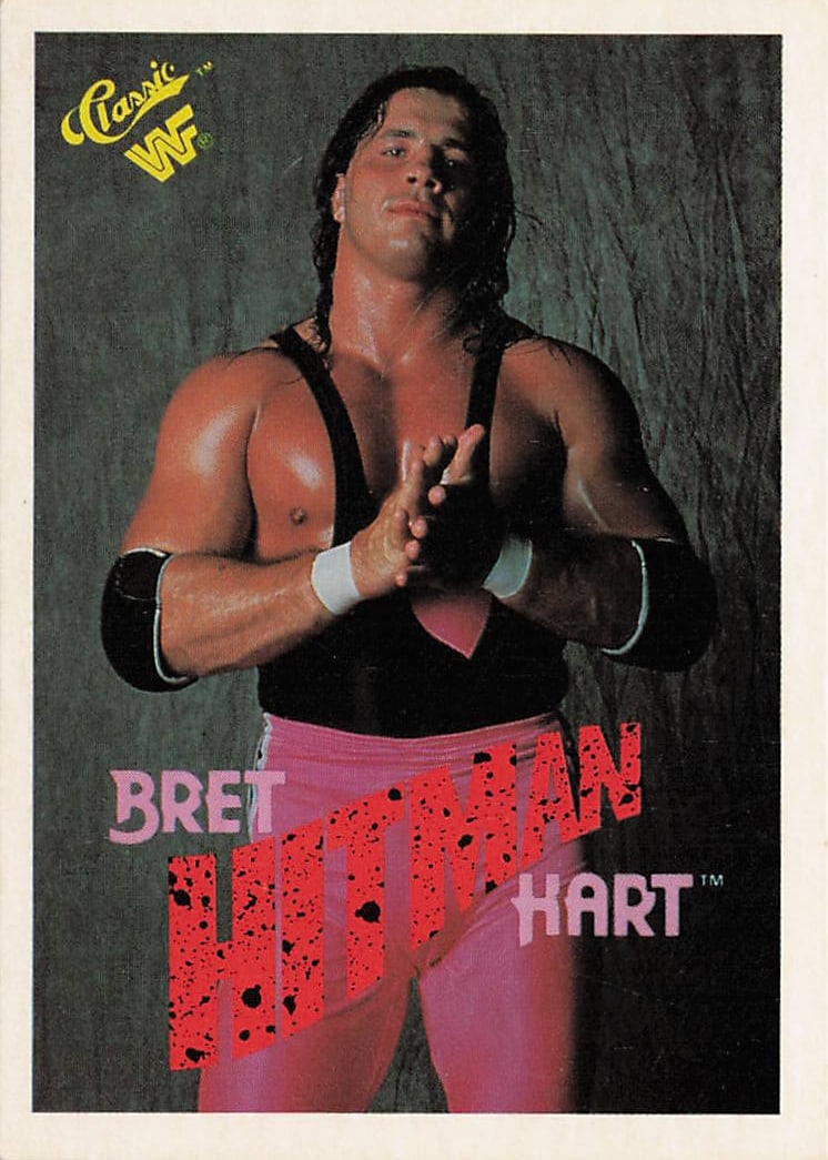 1990 Classic WWF Bret "Hitman" Hart #37 trading card: The 1990 Classic WWF Bret "Hitman" Hart #37 trading card features a thin white outer border framing a studio portrait of the WWE Hall of Famer Bret Hart clapping his hands together while looking