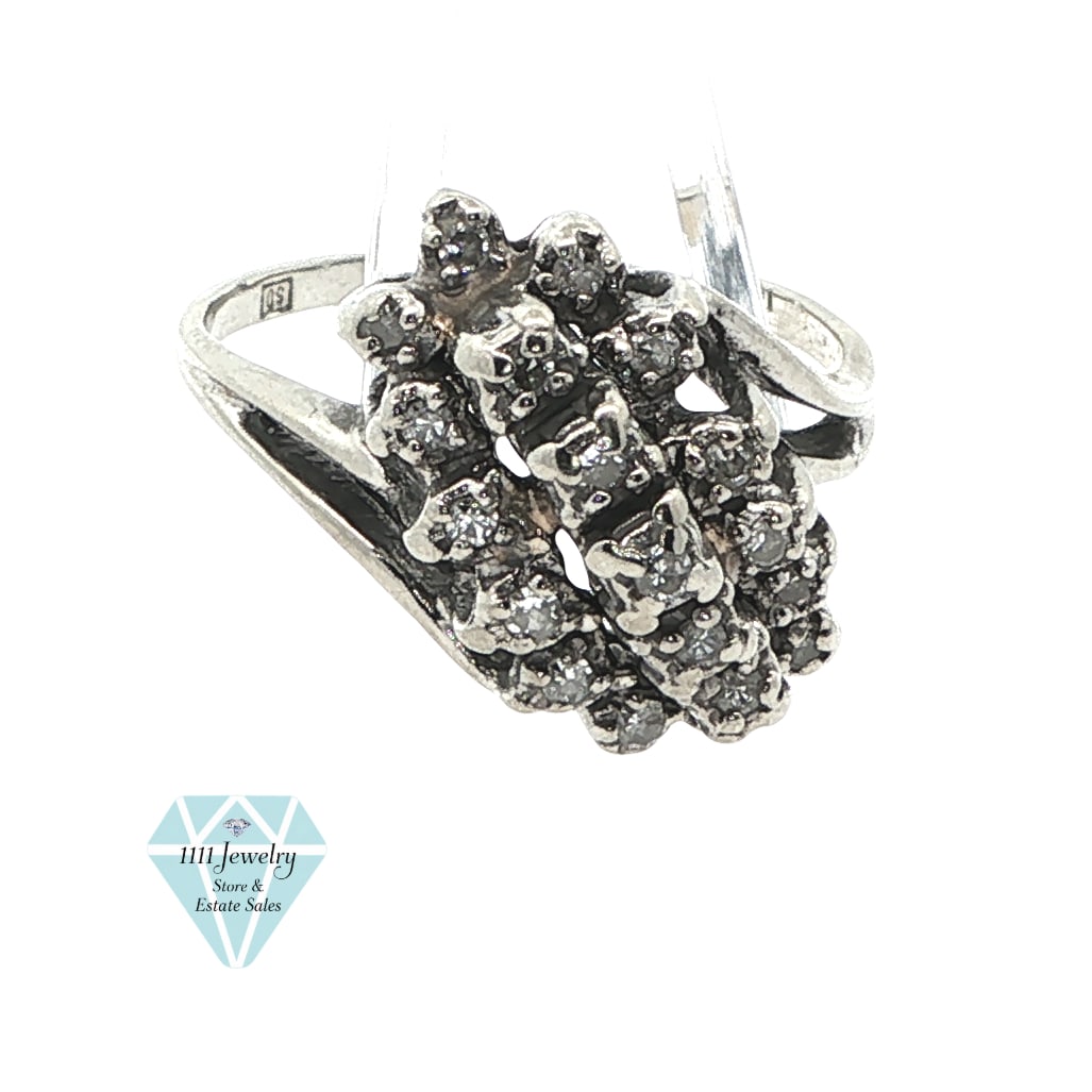 10K White Gold 0.12 CTW Diamond Cluster Cocktail Ring, Signed SD: Title: 10K White Gold 0.19 CTW Diamond Cluster Cocktail Ring, Signed SD Description: Elongated diamond cluster cocktail ring in 10K white gold, composed of twelve prong-set round diamonds arranged in 