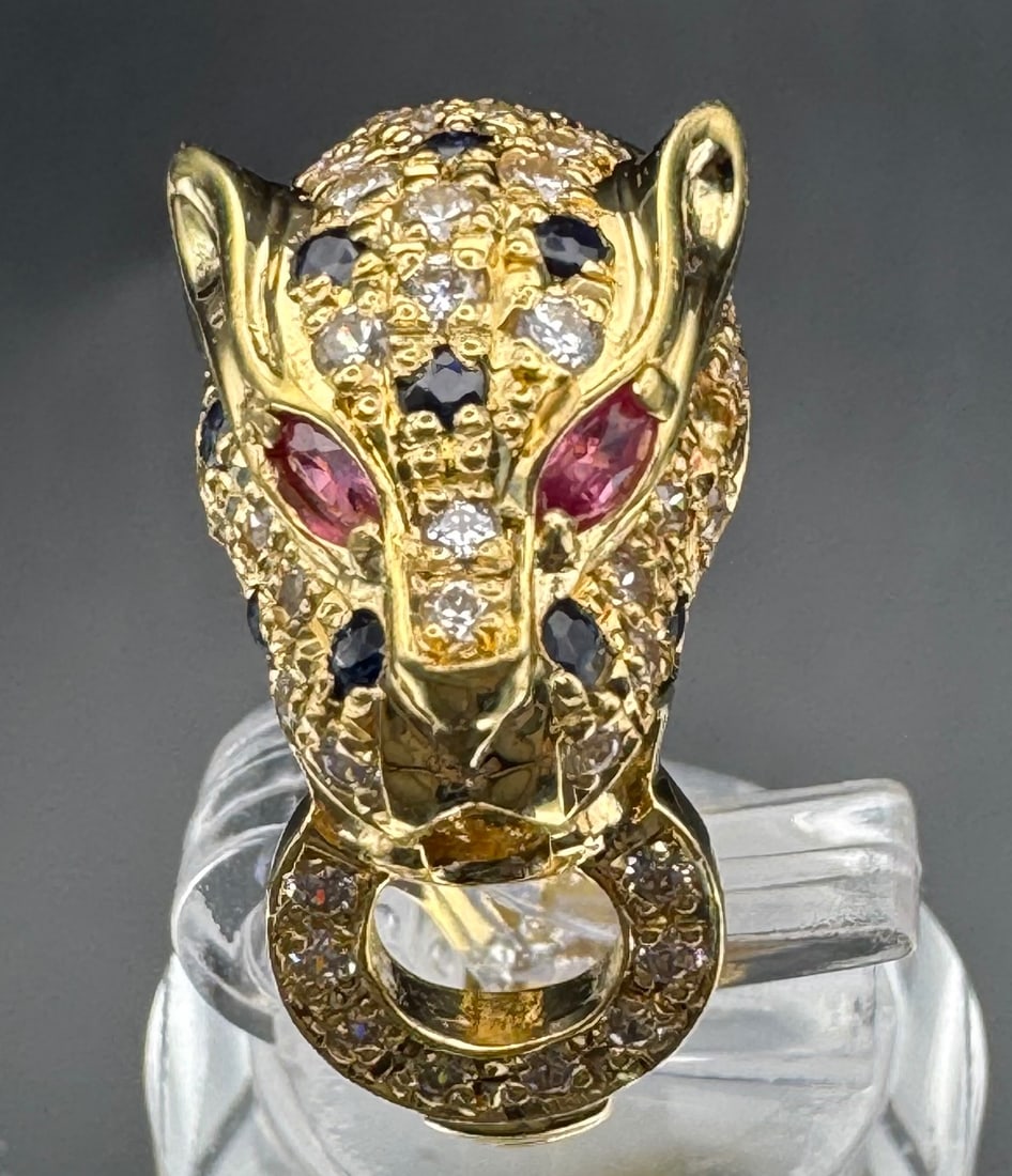 18K YELLOW GOLD 3D PANTHER RING SWAROVSKI SAPPHIRE RUBY: 18K yellow gold 3D panther ring featuring Swarovski crystals body, sapphire and ruby eyes. Total ring weight 8.3 grams, size 6.5, resizable. Stamped 18K. New condition. Item can be appraised upon requ