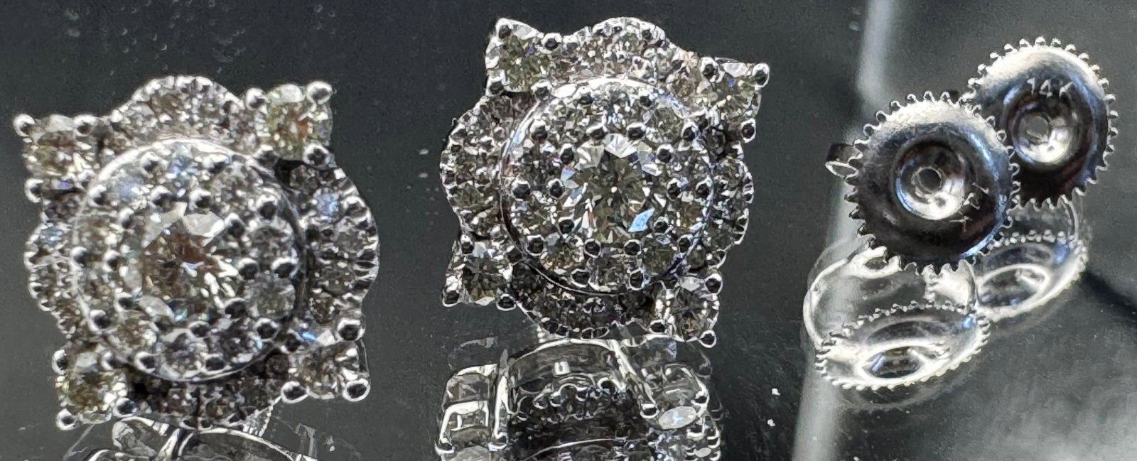 14K WHITE GOLD EARTH-MINED DIAMOND CLUSTER FLOWER STUD EARRINGS 1.25CT: 14K white gold diamond cluster flower stud earrings featuring 1.25ct round brilliant cut earth-mined diamonds, G-H color, VS1 clarity, prong set. 35 diamonds per earring. Screw-back closure. Total wei